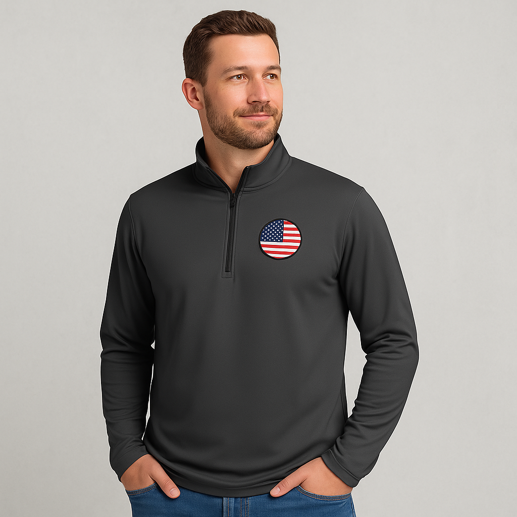 Promotional image of person wearing charcoal gray quarter-zip pullover with American flag patch