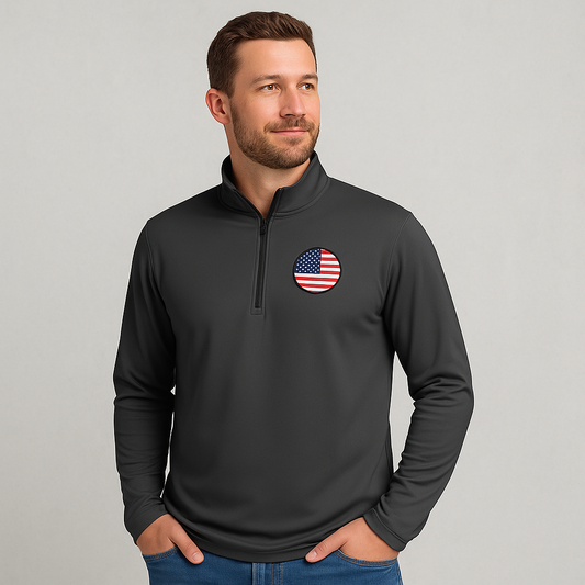 Promotional image of person wearing charcoal gray quarter-zip pullover with American flag patch